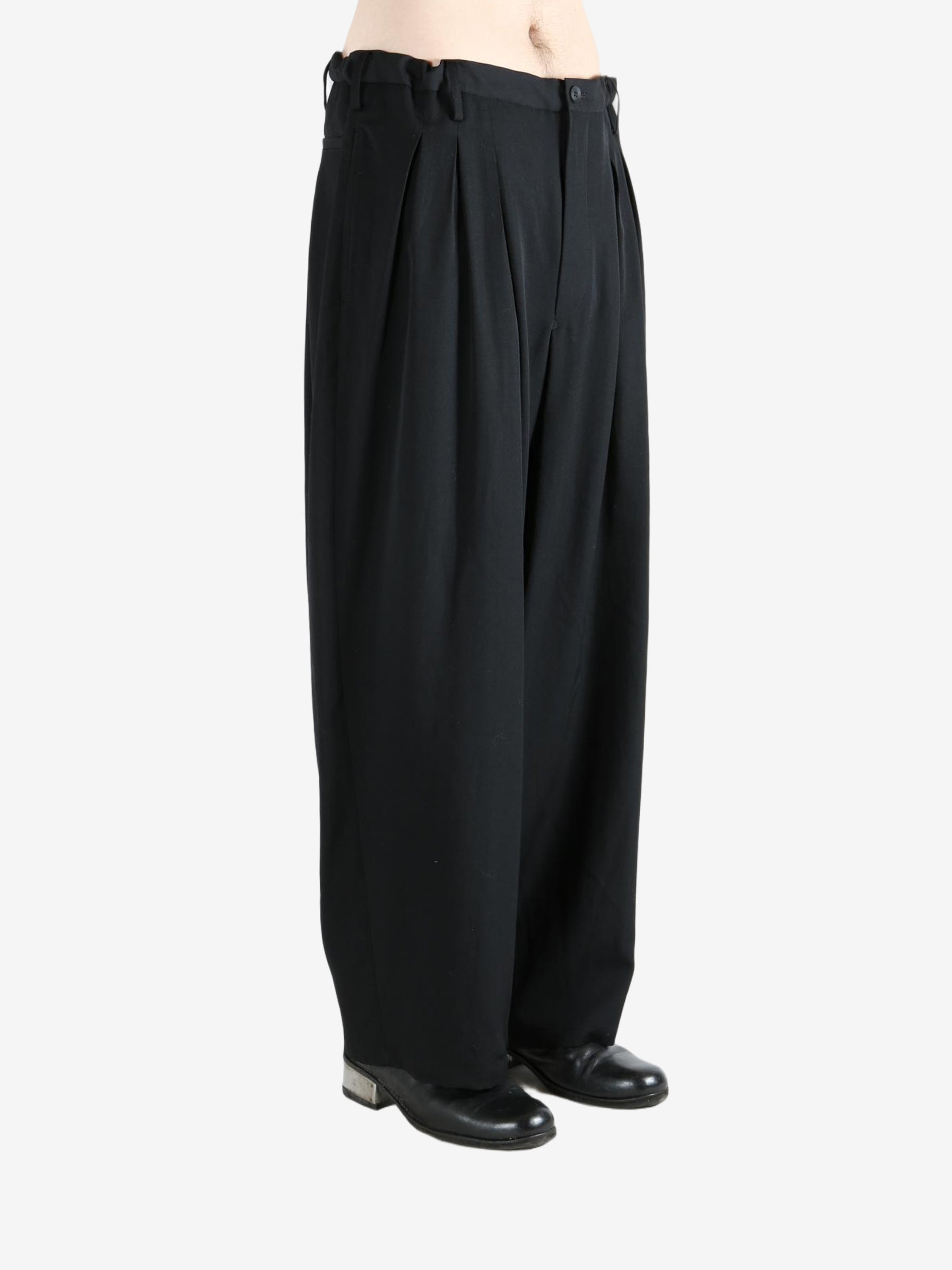 black pants  worn by a person, showing the pants fit