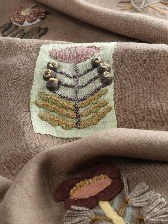 Close up of tan scarves, showing texture of the wool and linen fabric