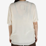 White top worn by a person, showing the top's fit