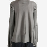 Grey knitwear worn by a person, showing the knitwear fit