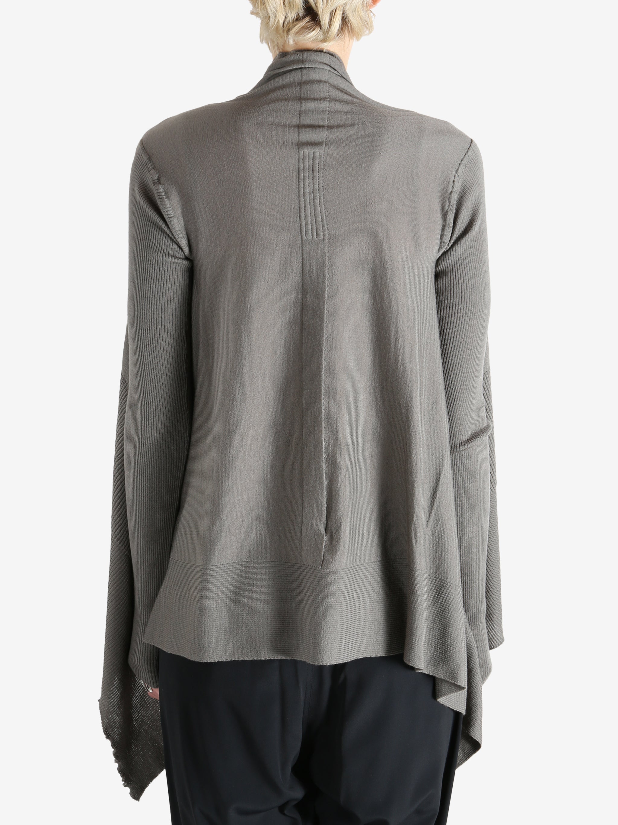 Grey knitwear worn by a person, showing the knitwear fit