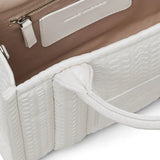 Close up of the white bag, showing texture of the leather fabric