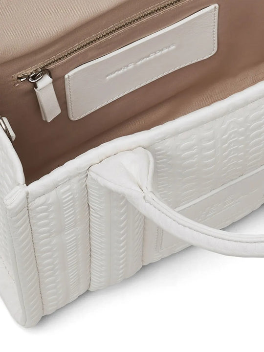Close up of the white bag, showing texture of the leather fabric