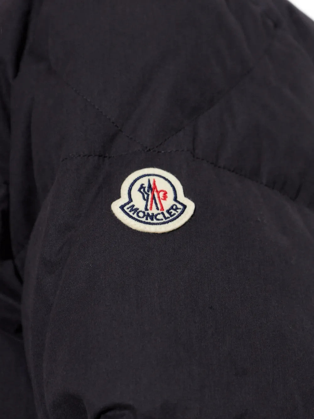 Close up of Black jacket, showing texture of the 100% cotton fabric