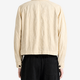 Tan jacket worn by a person, showing the tan jacket's fit