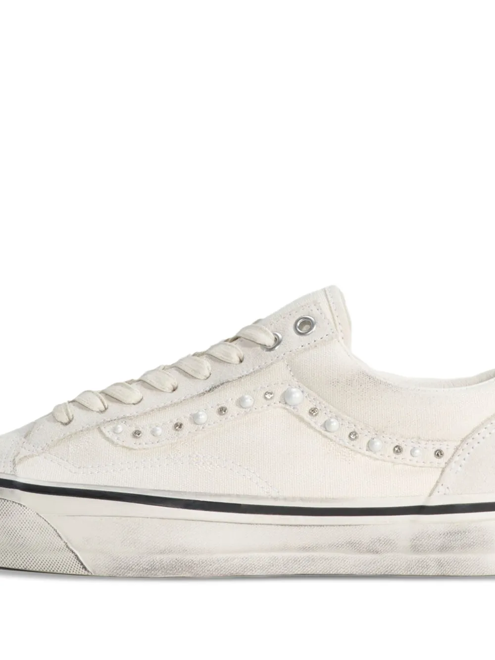 Close up of white sneaker, showing texture of the canvas fabric
