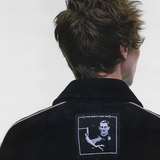 Black jacket worn by a person, showing the jacket fit