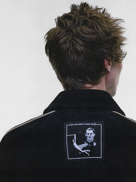 Black jacket worn by a person, showing the jacket fit