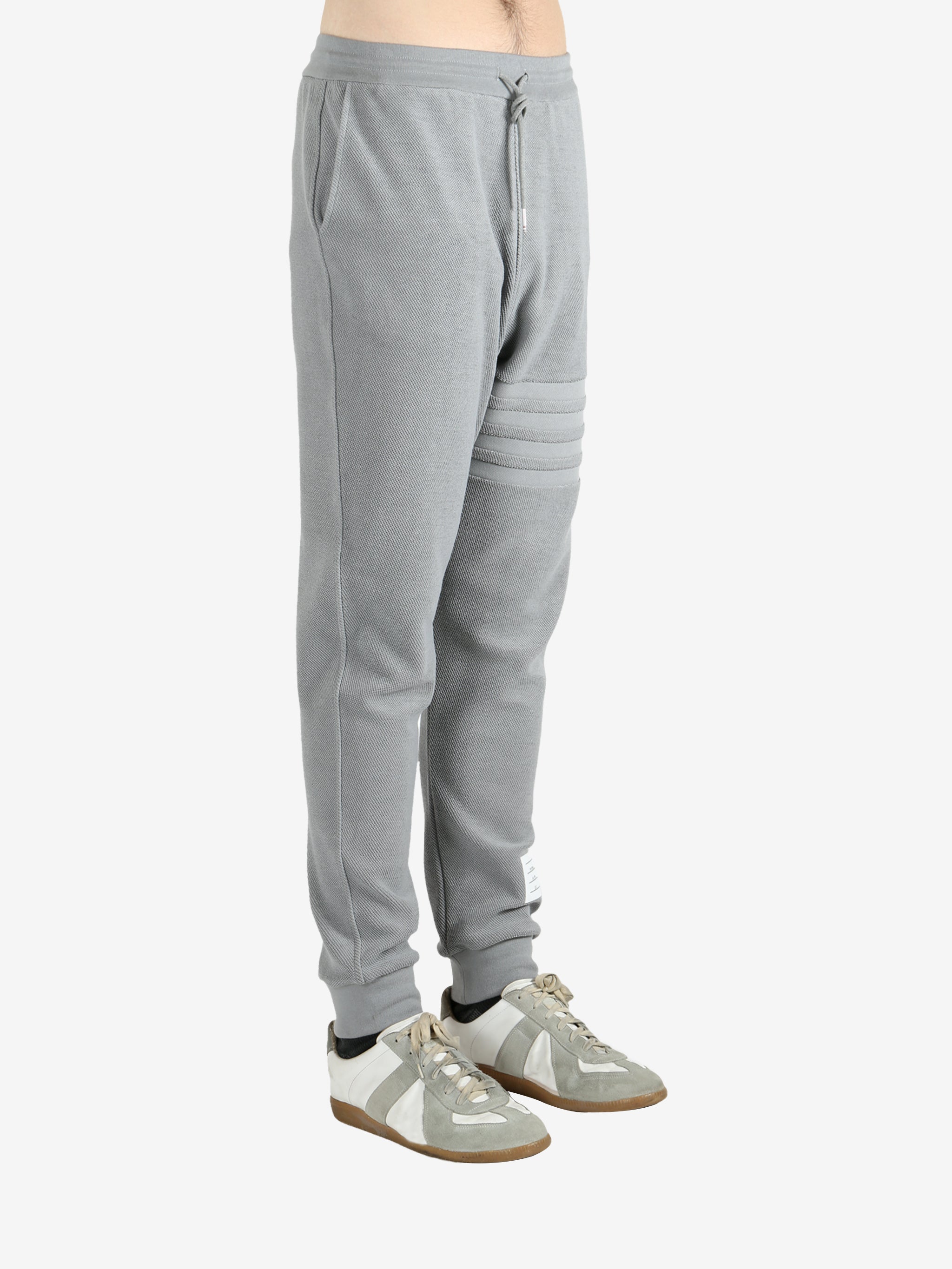 Grey pants worn by a person, showing the pants fit