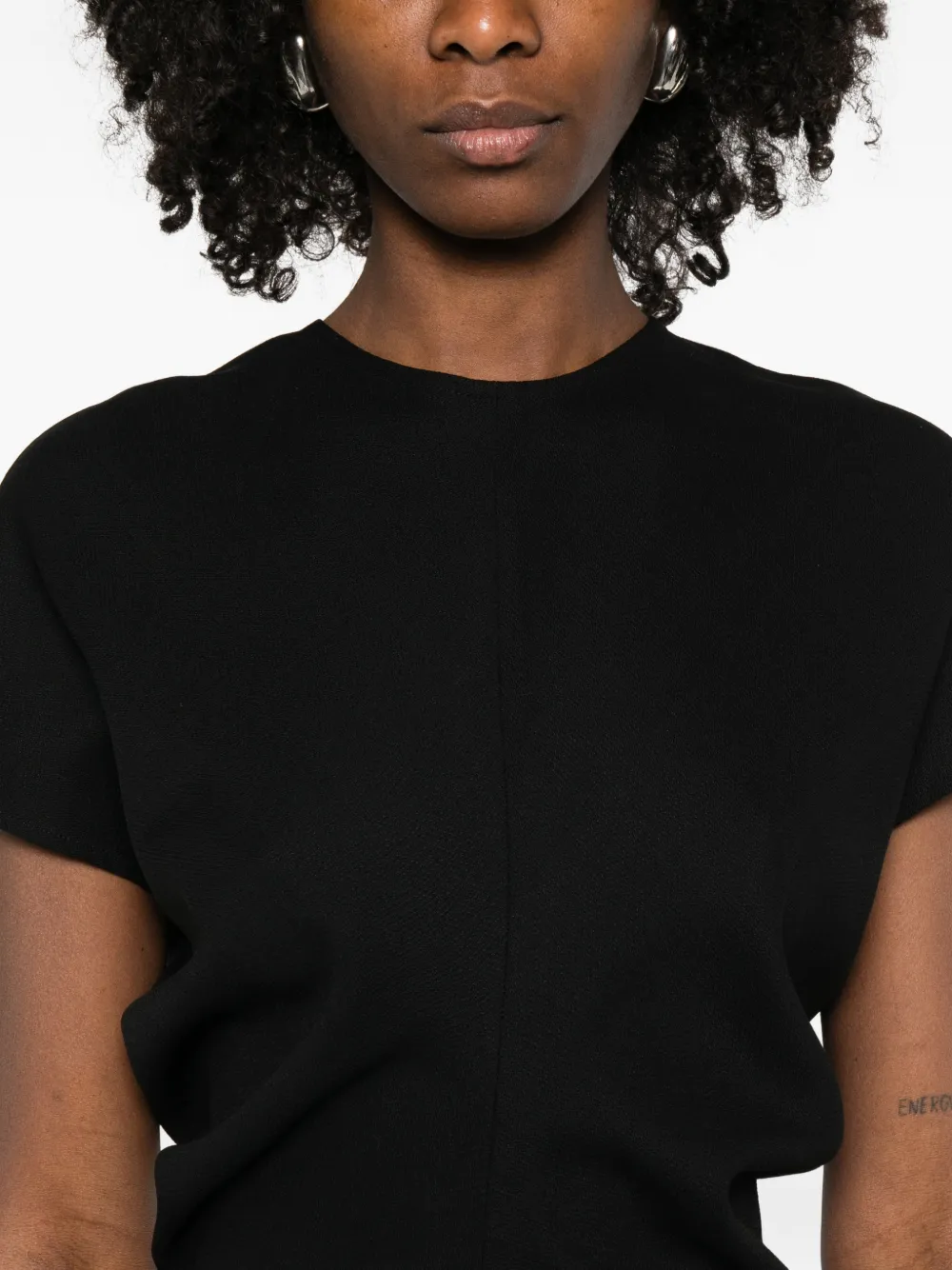 Black dress worn by a person, showing the dress fit