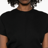 Black dress worn by a person, showing the dress fit