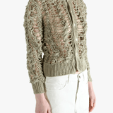 Green knitwear worn by a person, showing the knitwear fit