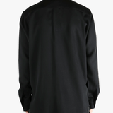 Black shirts worn by a person, showing the shirts fit