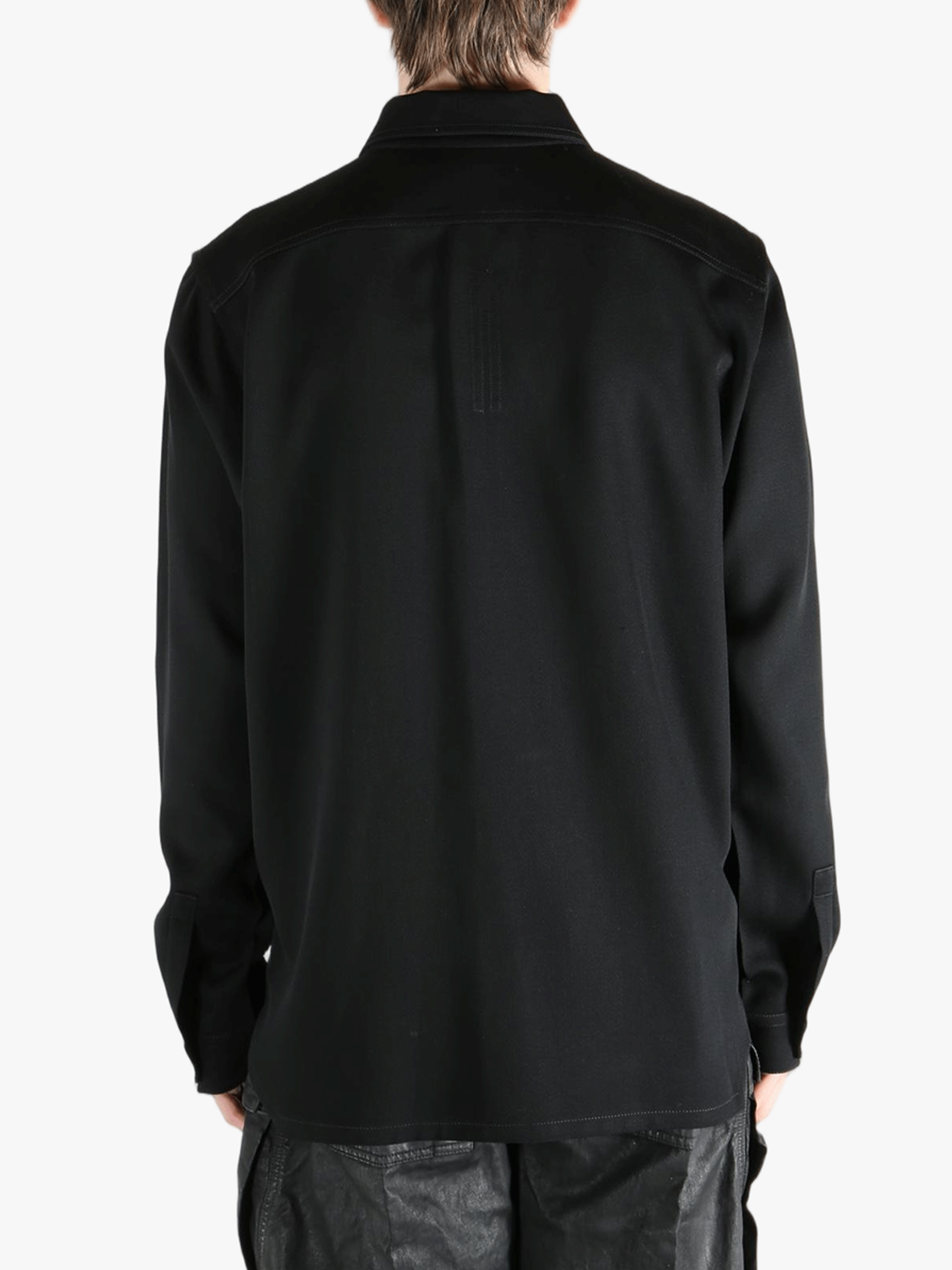 Black shirts worn by a person, showing the shirts fit