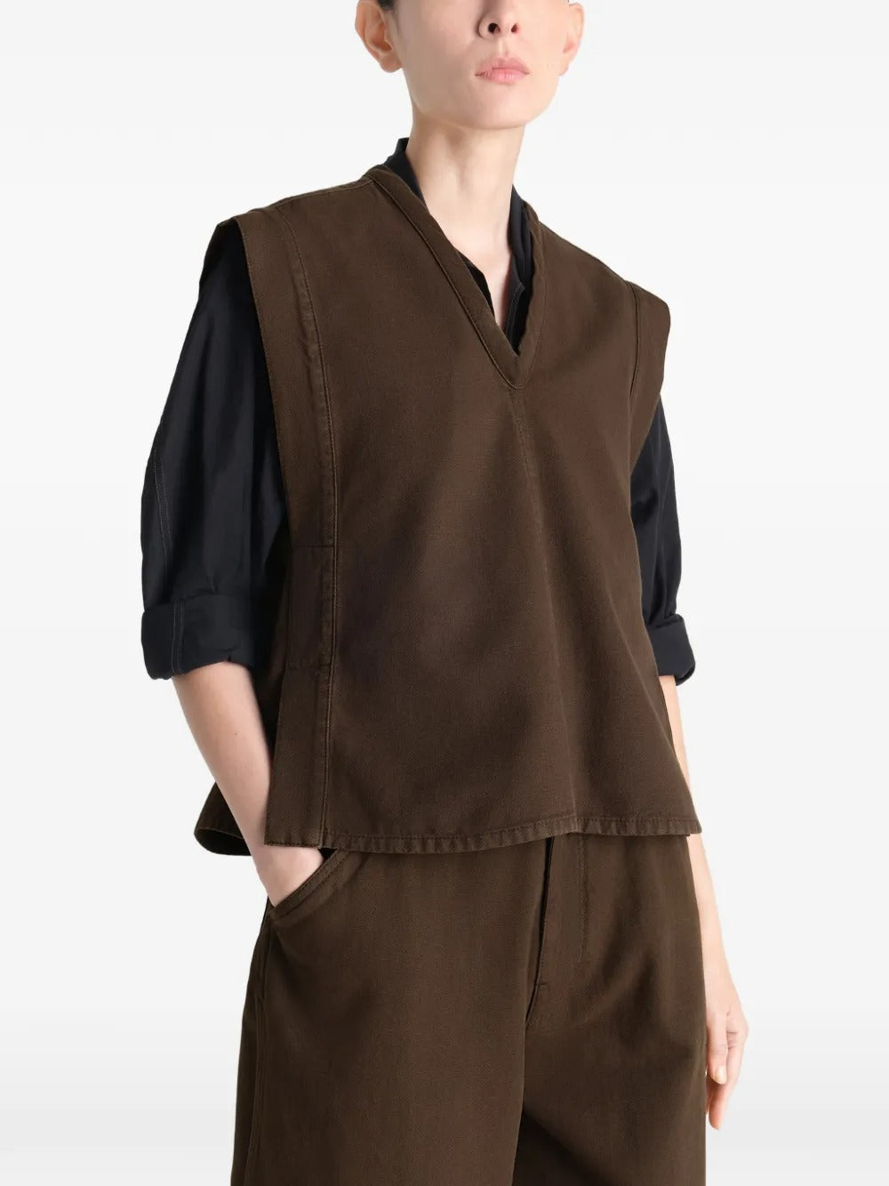 Brown top worn by a person, showing the top's fit