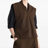 Brown top worn by a person, showing the top's fit