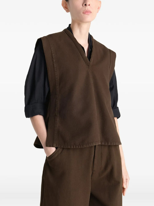 Brown top worn by a person, showing the top's fit