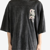 Black t-shirt worn by a person, showing the t-shirt's fit