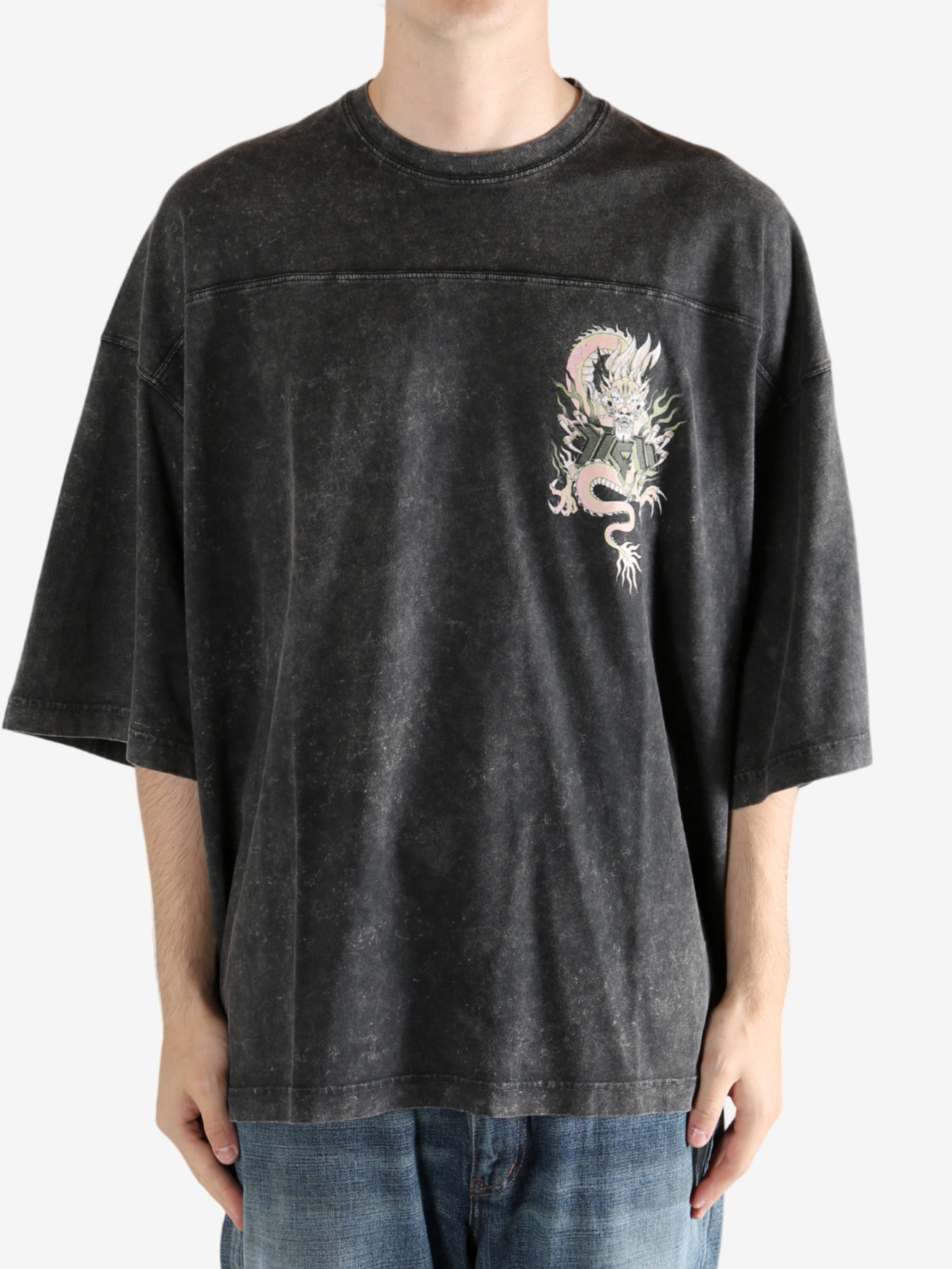 Black t-shirt worn by a person, showing the t-shirt's fit