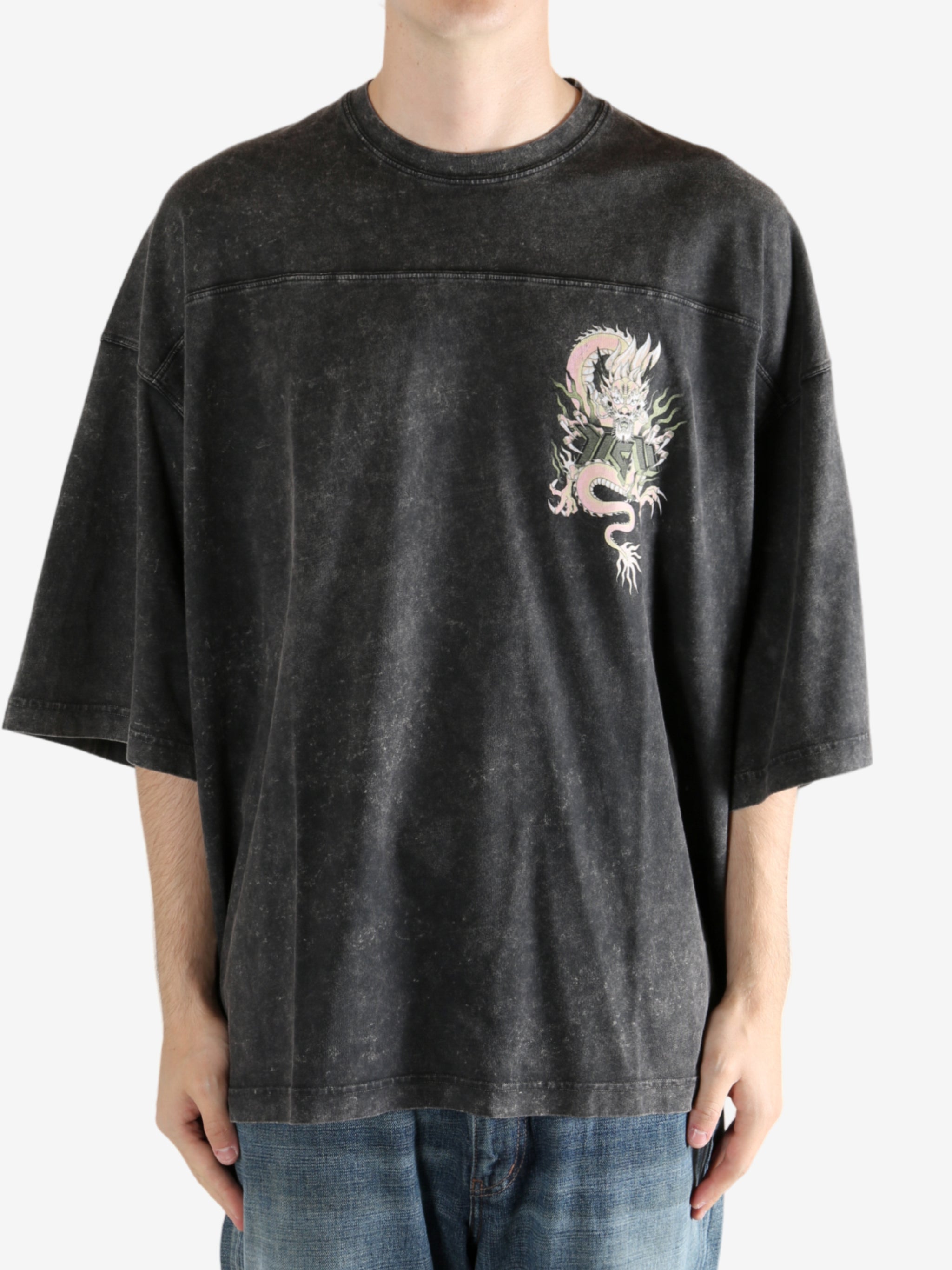 Black t-shirt worn by a person, showing the t-shirt's fit