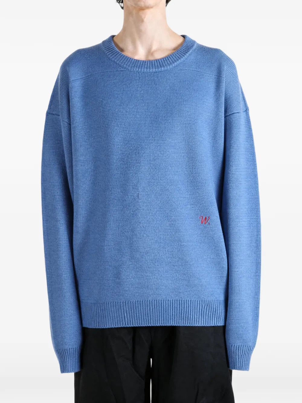 Blue knitwear worn by a person, showing the knitwear fit