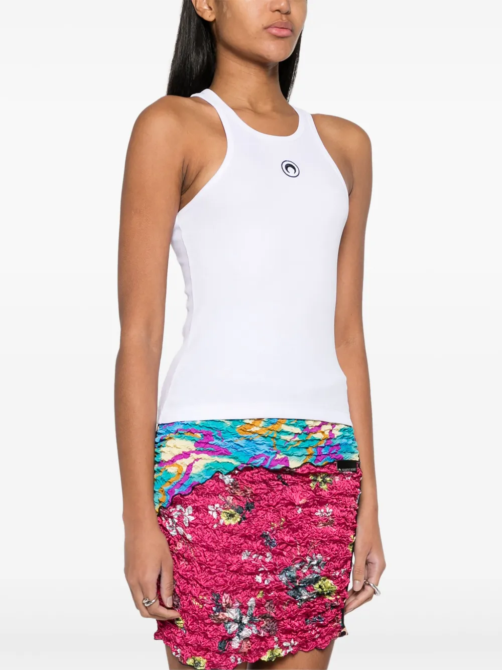 White top worn by a person, showing the top's fit