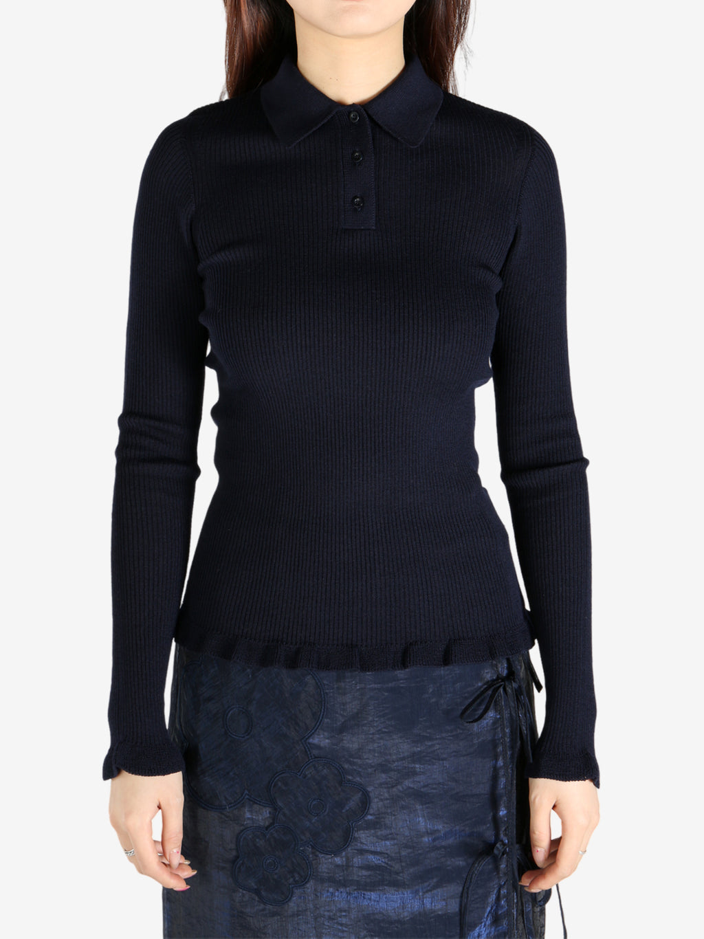 Navy top worn by a person, showing the top’s fit