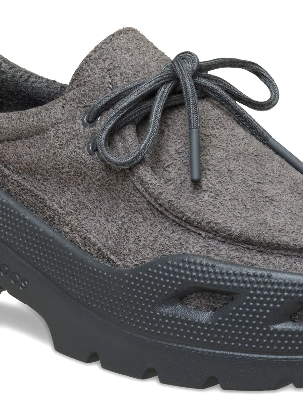 Close up of grey shoes, showing texture of the rubber fabric