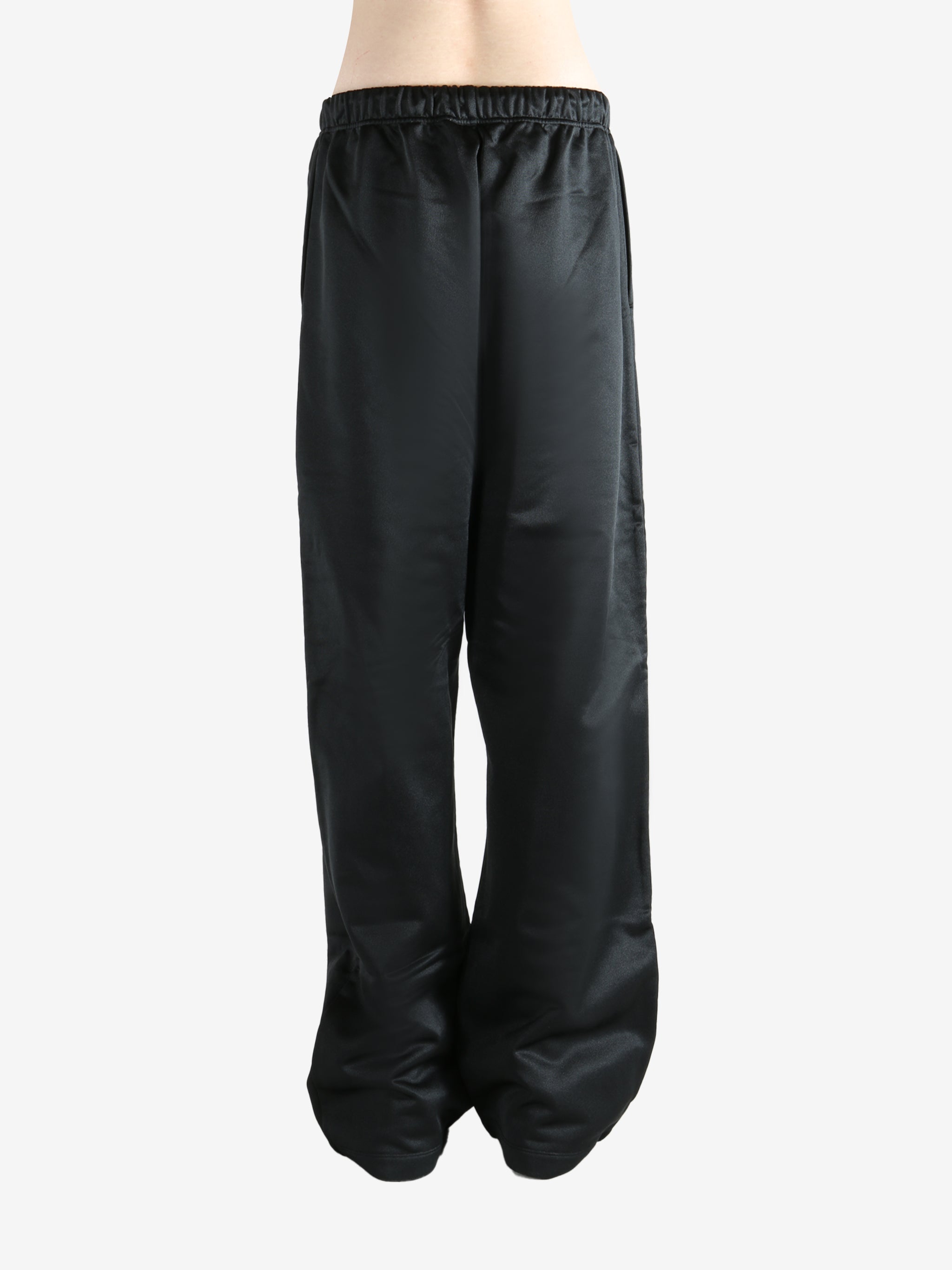 Black pants worn by a person, showing the pants fit