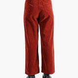 Red pants worn by a person, showing the pant's fit