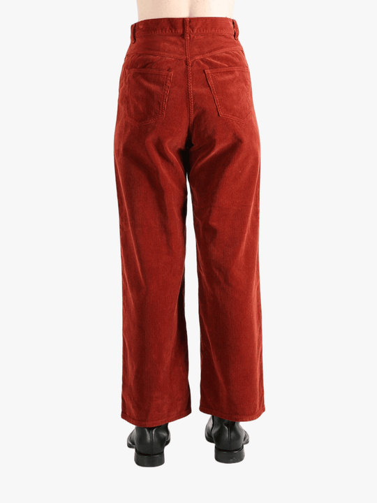 Red pants worn by a person, showing the pant's fit