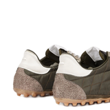 Close up of green shoes, showing texture of the polyester fabric