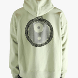 Green hoodie worn by a person, showing the hoodie's fit