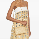 Tan bag worn by a person, showing the bag's fit