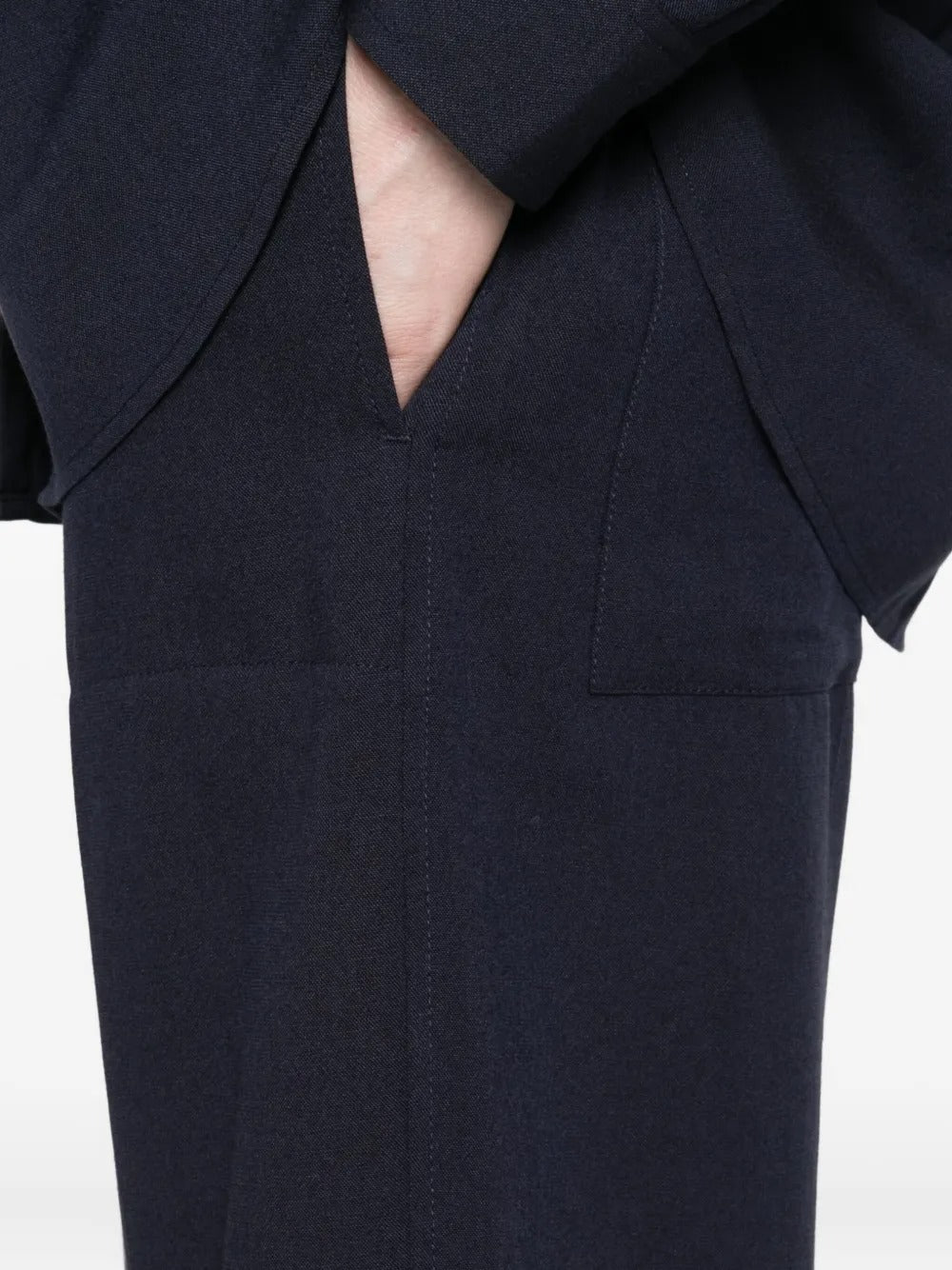 Close up of  navy pants, showing texture of the viscose fabric