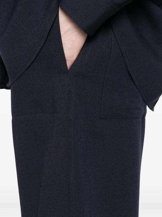 Close up of  navy pants, showing texture of the viscose fabric