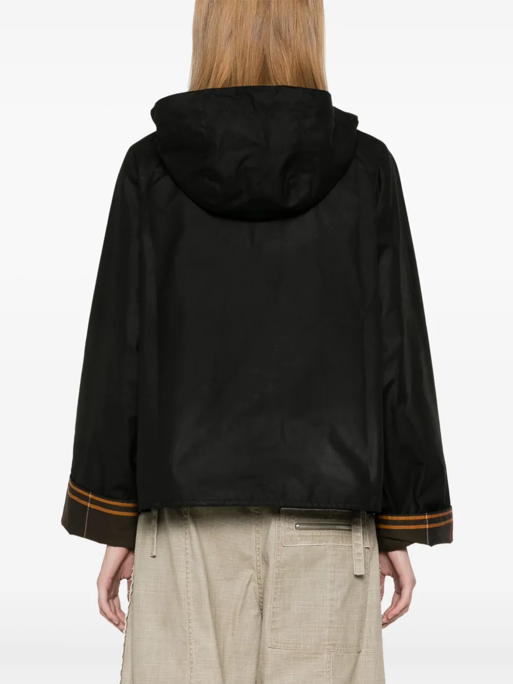 Black jacket worn by a person, showing the jacket fit