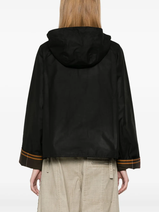 Black jacket worn by a person, showing the jacket fit