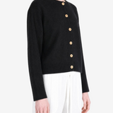Black knitwear worn by a person, showing the knitwear fit