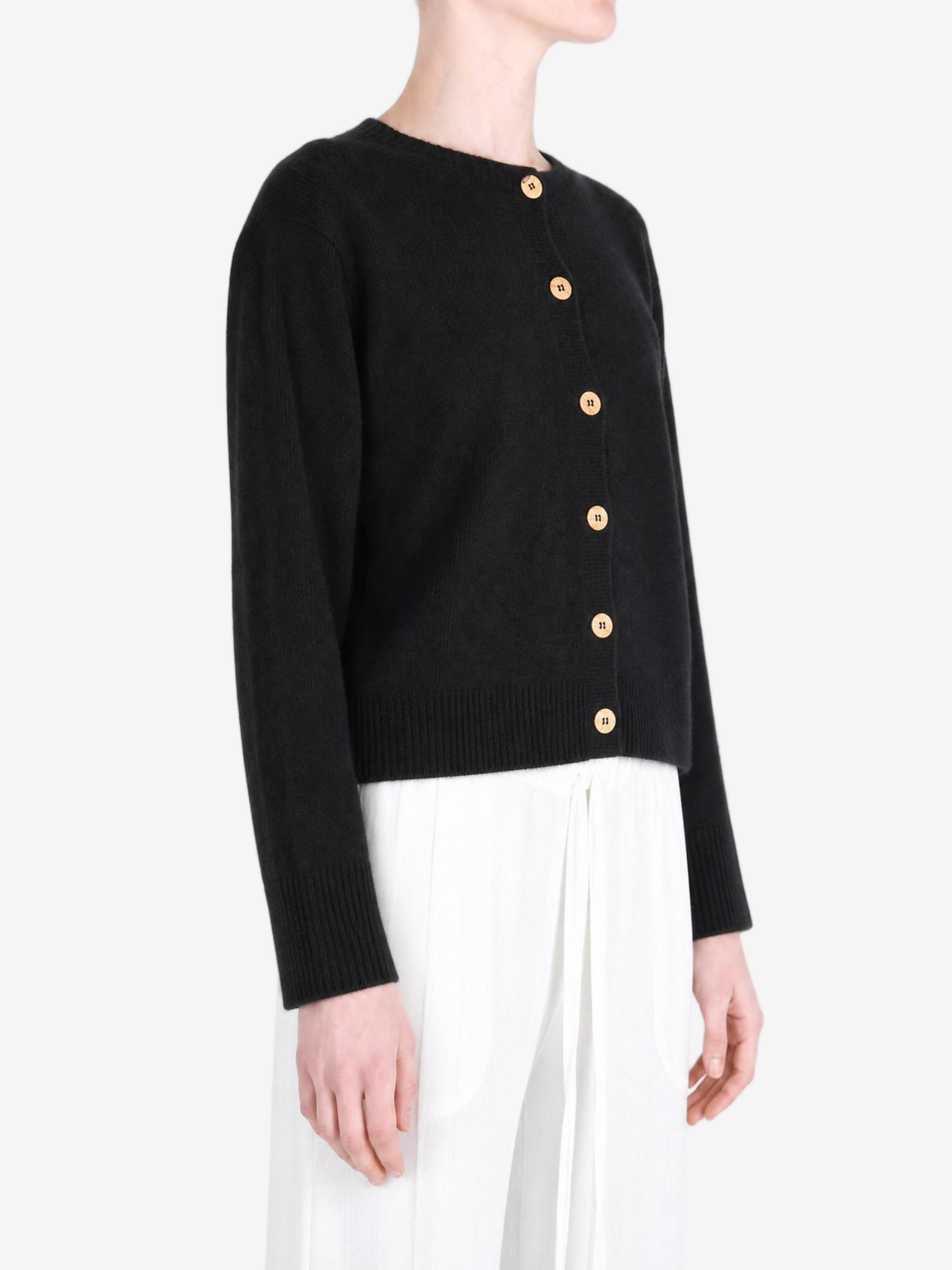 Black knitwear worn by a person, showing the knitwear fit