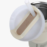 Close up of tan tumbler, showing texture of the stainless steel fabrica