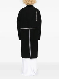 black jacket worn by a person, showing the jacket's fit

