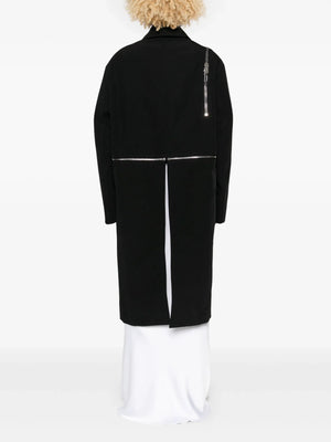 black jacket worn by a person, showing the jacket's fit
