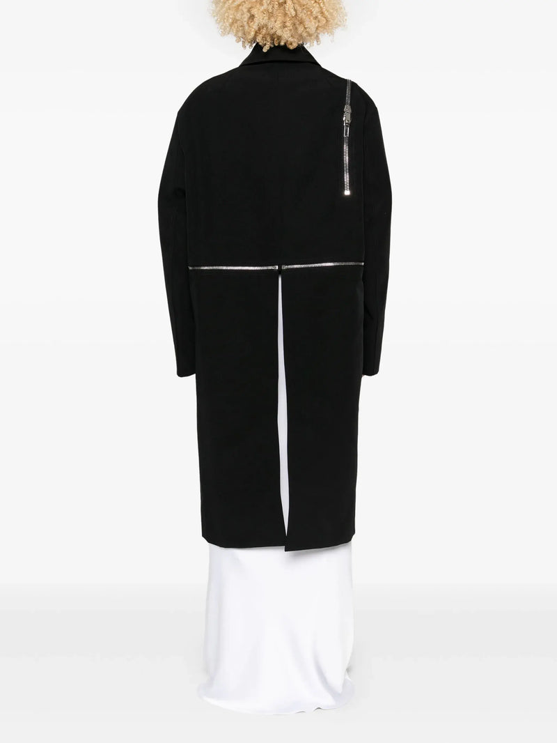 black jacket worn by a person, showing the jacket's fit
