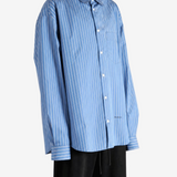 Blue shirt worn by a person, showing the shirt fit