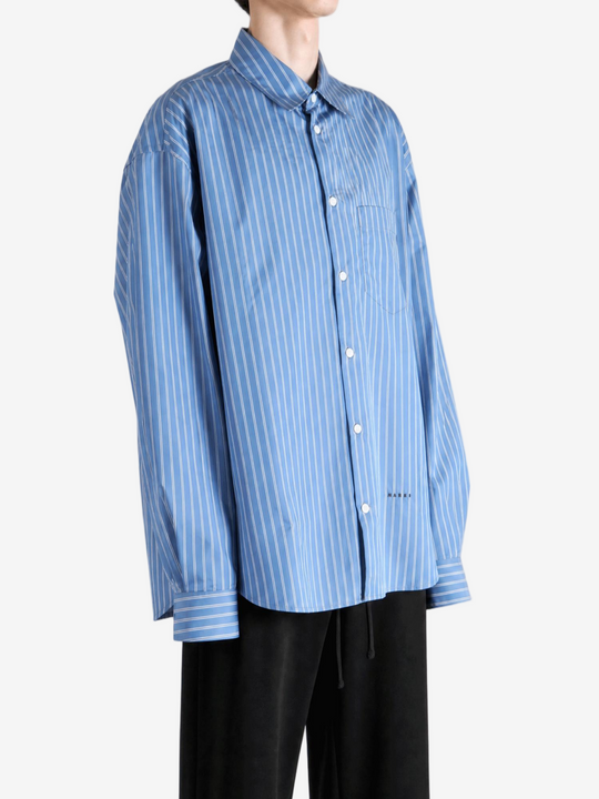 Blue shirt worn by a person, showing the shirt fit