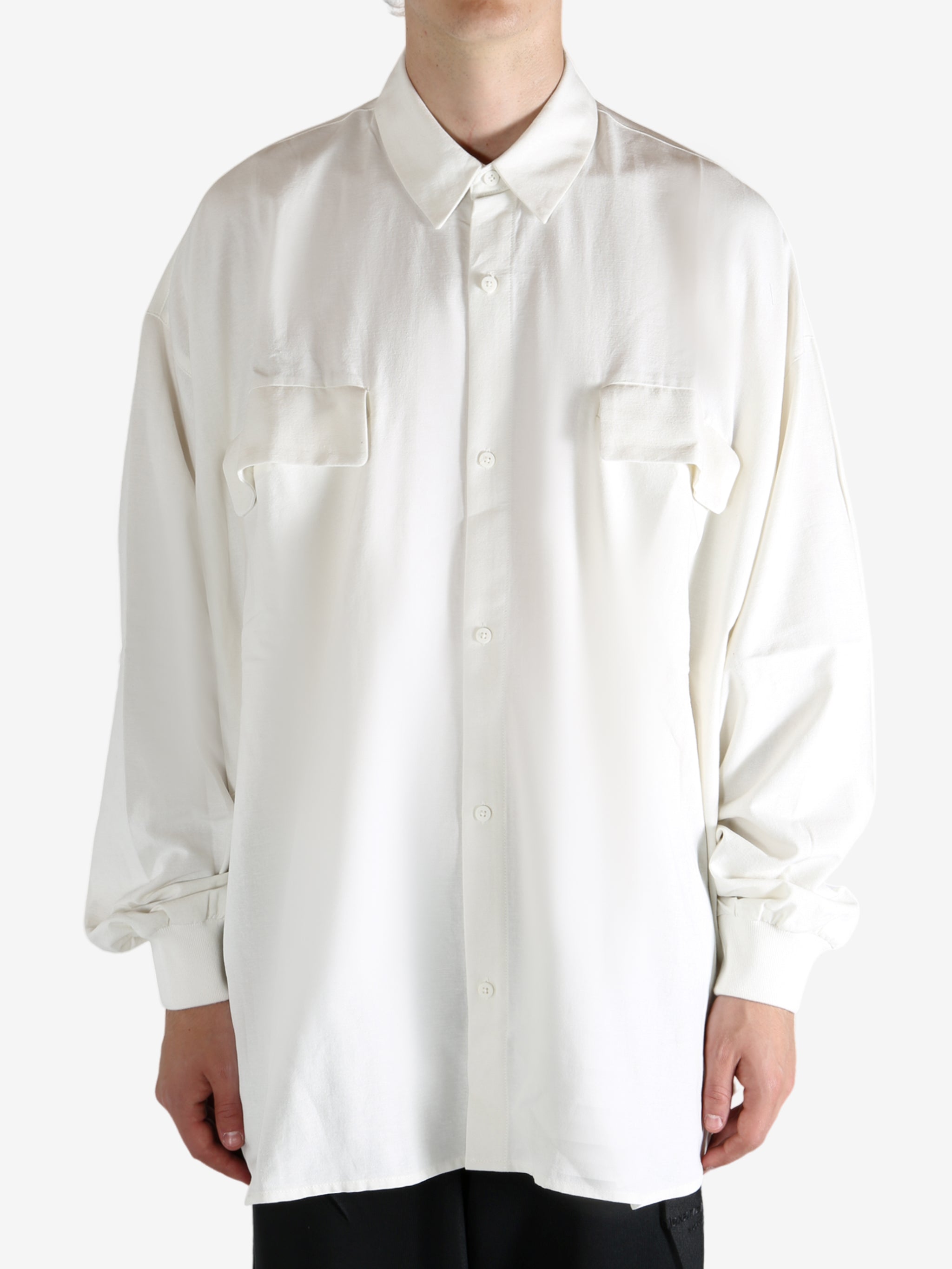 White shirt worn by a person, showing the shirt's fit