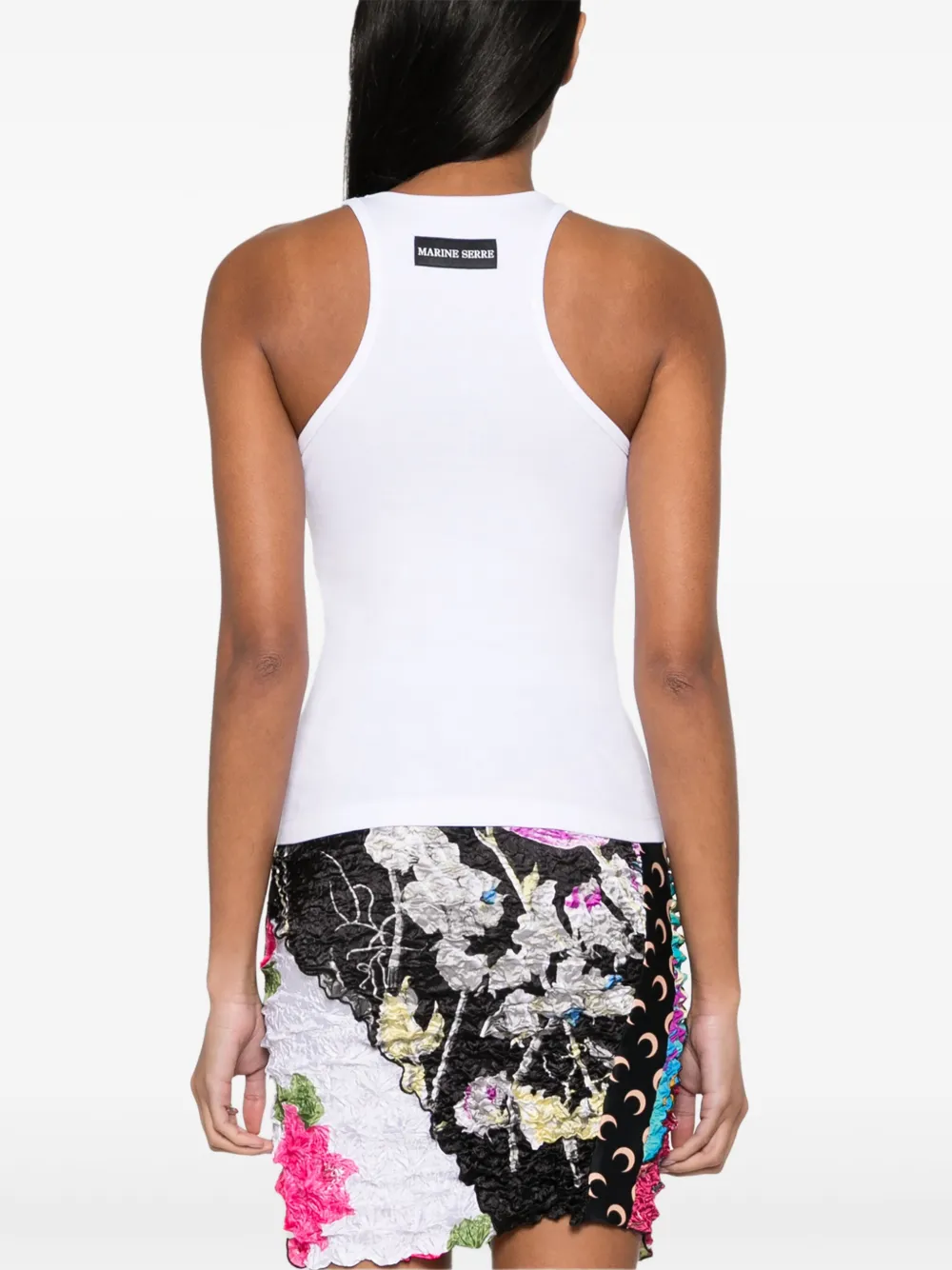 White top worn by a person, showing the top's fit