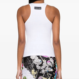 White top worn by a person, showing the top's fit