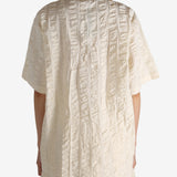 White shirt worn by a person, showing the shirt's fit